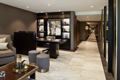 Photo of a large modern foyer in London with brown walls, marble flooring, a double front door, a brown front door and multi-coloured floors.