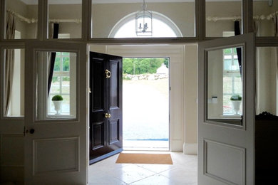 This is an example of a classic front door in London with travertine flooring and a single front door.