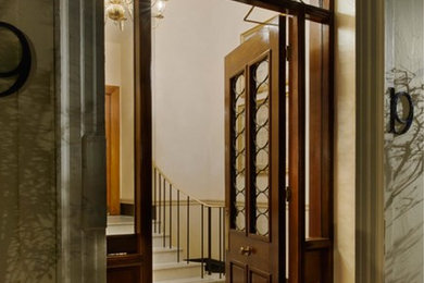 Photo of a large traditional entrance in London with beige walls, marble flooring, a double front door and a dark wood front door.