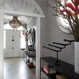 Photo of a bohemian hallway in London with grey walls, a double front door, a white front door and grey floors.
