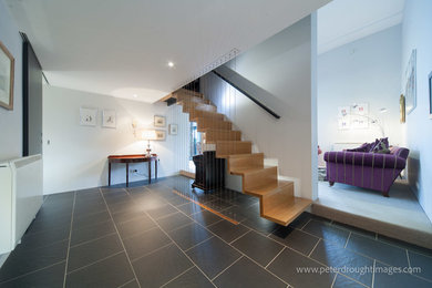 Large contemporary hallway in Other with grey walls, slate flooring and grey floors.