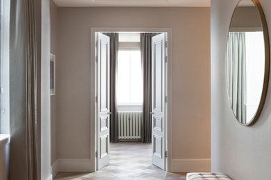 Exemple d'une grande entrée chic avec un couloir, un mur gris, parquet clair, une porte double et une porte grise.