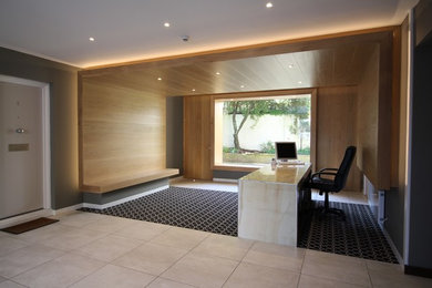 Medium sized contemporary vestibule in London with carpet and multi-coloured floors.