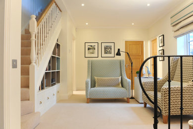 Photo of a medium sized contemporary foyer in West Midlands with white walls, carpet and beige floors.