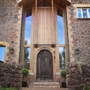 Design ideas for a large classic front door in Devon with brick flooring, a single front door and a dark wood front door.