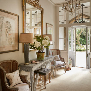 Large hallway in Other with grey walls, carpet, a double front door and beige floors.