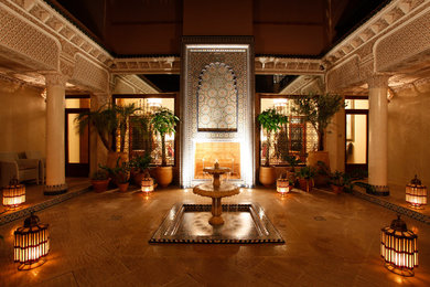 This is an example of a large traditional hallway in Other with beige walls and marble flooring.