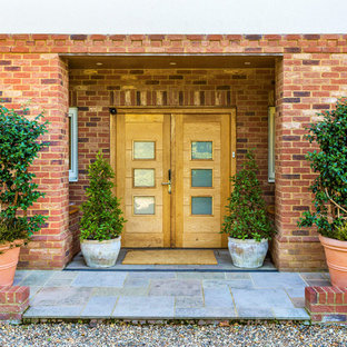 Contemporary front door in Surrey with a double front door, a light wood front door and grey floors.