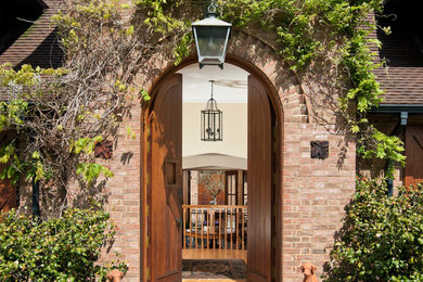 This is an example of a classic front door in Sussex with a double front door and a medium wood front door.