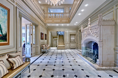Design ideas for an expansive traditional foyer in London with grey walls and marble flooring.