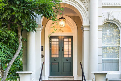 This is an example of a classic entrance in Other with a double front door, a green front door and feature lighting.