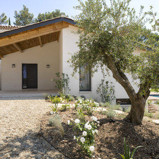Idée de décoration pour une porte d'entrée méditerranéenne avec un mur blanc, une porte simple et une porte noire.