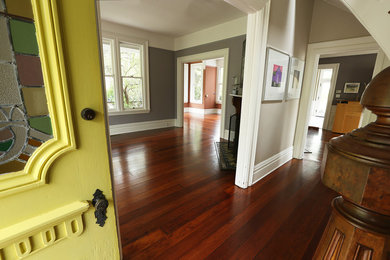 Entryway - traditional dark wood floor entryway idea in Other