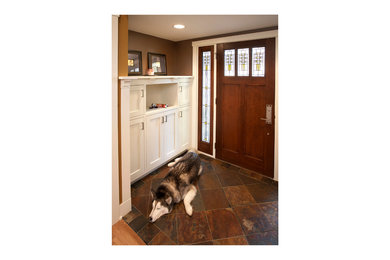 Entryway - small craftsman slate floor entryway idea in Minneapolis with brown walls and a dark wood front door