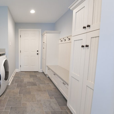 Example of a mid-sized cottage vinyl floor and multicolored floor entryway design in Other with blue walls and a white front door