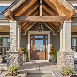 Example of a cottage entryway design in Columbus with brown walls and a medium wood front door