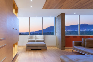 Medium sized contemporary vestibule in Vancouver with orange walls, light hardwood flooring and a light wood front door.