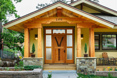 Example of a huge arts and crafts pivot front door design in Albuquerque with a medium wood front door