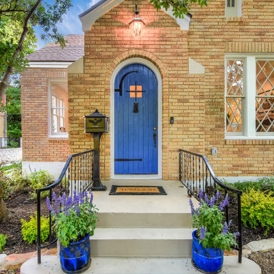 Inspiration for a huge transitional gray floor entryway remodel in Austin with a blue front door