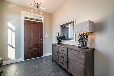 This is an example of a medium sized traditional foyer in Other with beige walls, porcelain flooring, a single front door and a dark wood front door.