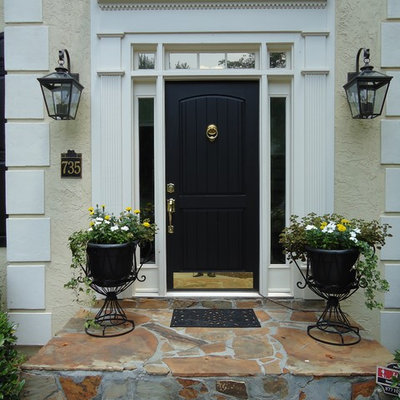 Example of a classic entryway design in Atlanta with a black front door