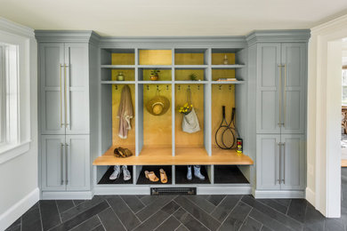Entryway - large contemporary slate floor and black floor entryway idea in Providence with white walls and a black front door