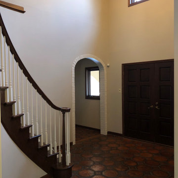 After - Painted Entryway wall, brick archways and stair spindles