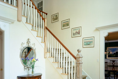 Example of a classic light wood floor foyer design in Bridgeport with white walls