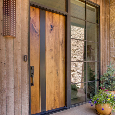 Mid-sized trendy concrete floor entryway photo in Denver with a medium wood front door