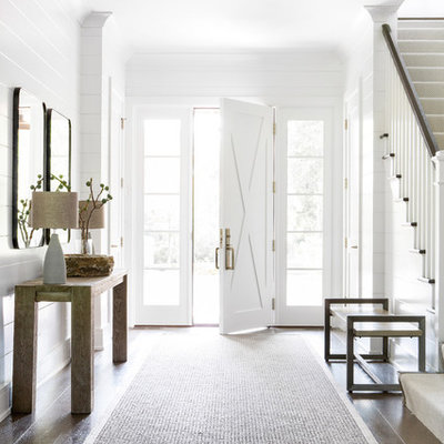 Mid-sized farmhouse dark wood floor entryway photo in New York with white walls and a white front door