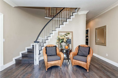 Photo of a large foyer in Boise with beige walls, dark hardwood flooring and brown floors.