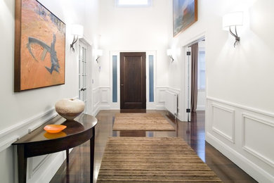 Ejemplo de puerta principal contemporánea grande con paredes blancas, suelo de madera oscura, puerta simple y puerta de madera oscura