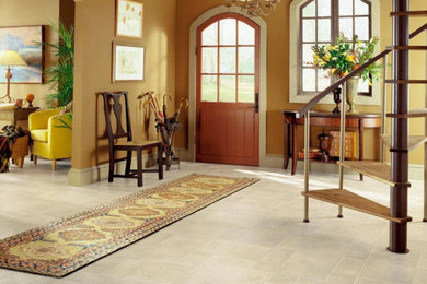 Example of a mid-sized transitional vinyl floor and gray floor entryway design in Other with beige walls and a dark wood front door