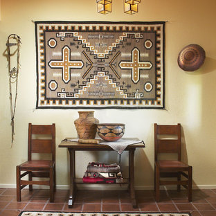 Inspiration for a mid-sized southwestern ceramic tile entryway remodel in Phoenix with yellow walls and a dark wood front door