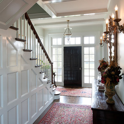 Example of a mid-sized classic dark wood floor entryway design in Dallas with a black front door and white walls
