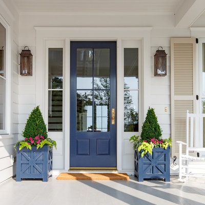 Inspiration for a mid-sized country painted wood floor and gray floor entryway remodel in Jacksonville with white walls and a blue front door