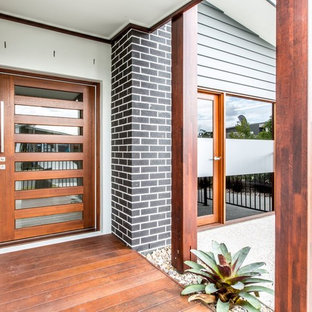 Contemporary front door in Sunshine Coast with a single front door and a medium wood front door.