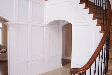Inspiration for a mid-sized timeless foyer remodel in New York with white walls