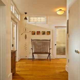 Entry hall - cottage medium tone wood floor entry hall idea in New York with beige walls