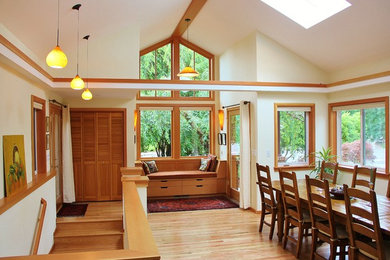 Example of a trendy light wood floor entryway design in Seattle with a glass front door