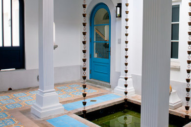 Entryway - mid-sized traditional concrete floor entryway idea in Miami with white walls and a blue front door