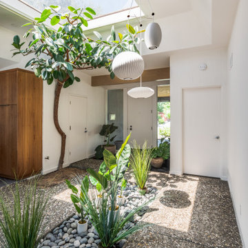 Beautiful Entry With Massive Skylight, Atrium, and Abstract Lantern Pendant Ligh