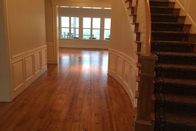 This is an example of a medium sized classic foyer in Houston with beige walls and light hardwood flooring.