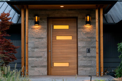 Mid-century modern entryway photo in Seattle with a medium wood front door