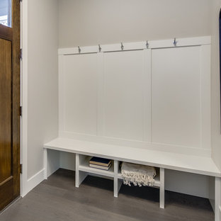 Example of a small transitional light wood floor and beige floor entryway design in Other with beige walls and a dark wood front door