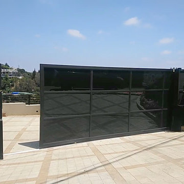 Black glass and aluminum sliding gate.