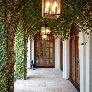 Inspiration for a mediterranean double front door remodel in Houston with a glass front door
