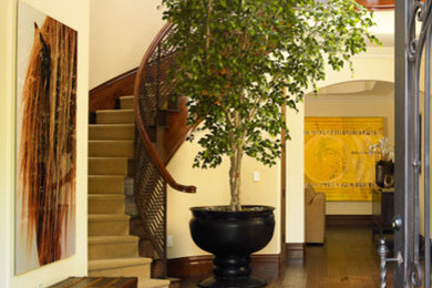 Aménagement d'un hall d'entrée méditerranéen de taille moyenne avec un mur beige, parquet foncé, une porte simple, une porte métallisée et un sol marron.