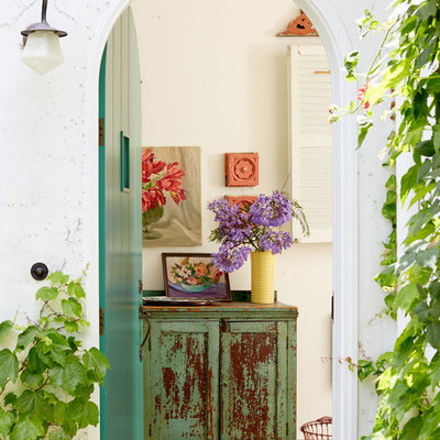 Example of a small cottage chic entryway design in Los Angeles with white walls and a green front door