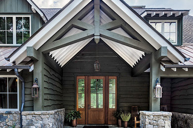 Example of a large farmhouse slate floor entryway design in Other with green walls and a medium wood front door